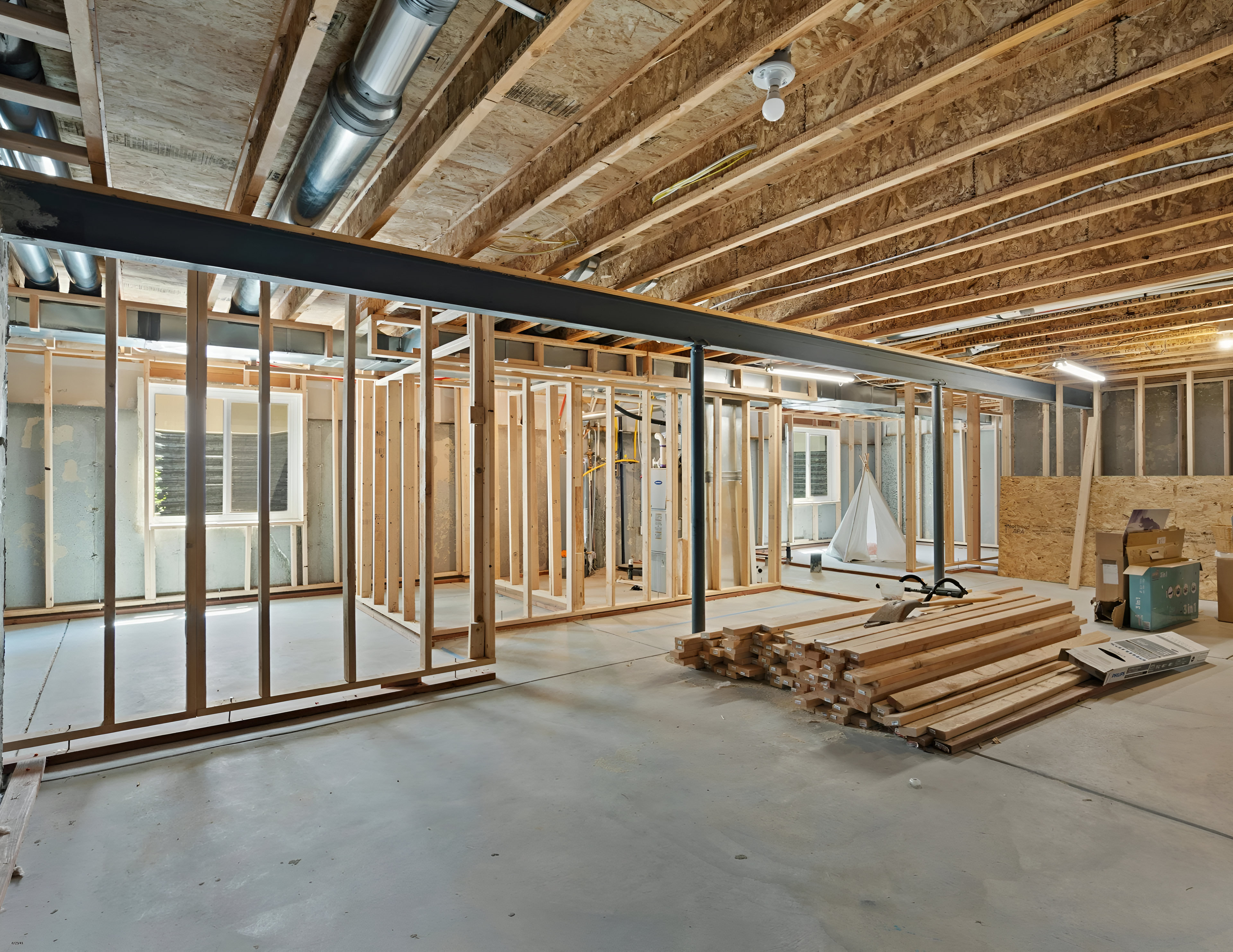 Wood-framed interior with open stud walls before drywall installation